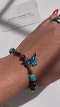 Load and play video in Gallery viewer, Tigers eye X Nazar Speak Your Truth Charm Bracelet
